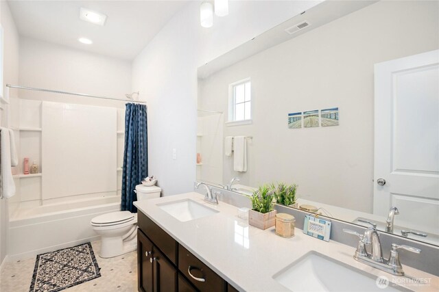 full bathroom with a sink, shower / tub combo with curtain, toilet, and visible vents
