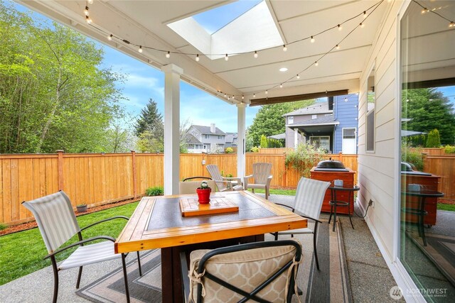 view of patio with a fenced backyard and outdoor dining space