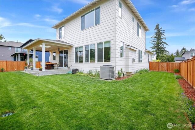 back of house with central air condition unit, a fenced backyard, a yard, and a patio area