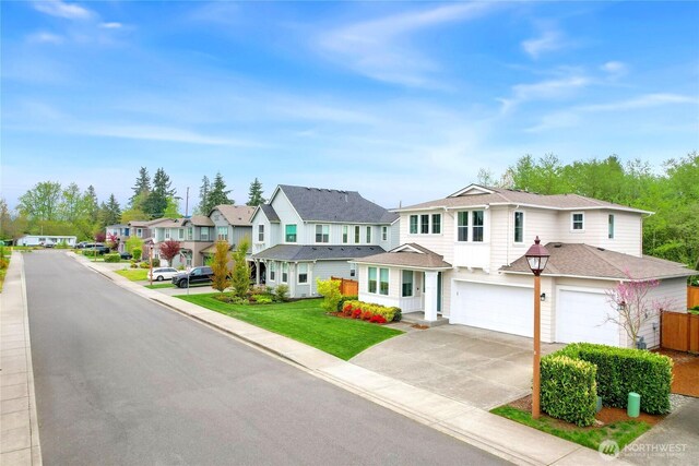 traditional-style home featuring a residential view, concrete driveway, and a garage