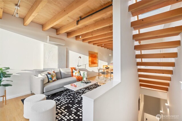 115 E Allison St, Seattle, WA 98102 - living area featuring wood ceiling, a wall unit AC, wood finished floors, baseboards, and beamed ceiling