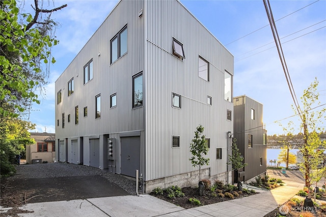 115 E Allison St, Seattle, WA 98102 - view of building exterior with a garage and gravel driveway