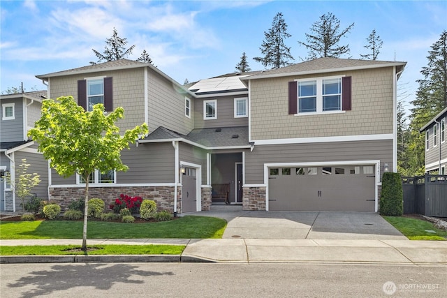 32943 Ash Ave SE, Black Diamond, WA 98010 - view of front of property featuring a garage, concrete driveway, fence, and stone siding