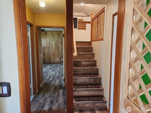 stairs featuring wood finished floors