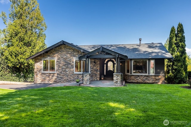 craftsman-style house featuring a front yard and stone siding