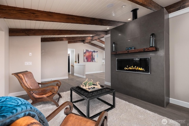 living area with wooden ceiling, beam ceiling, and wood finished floors