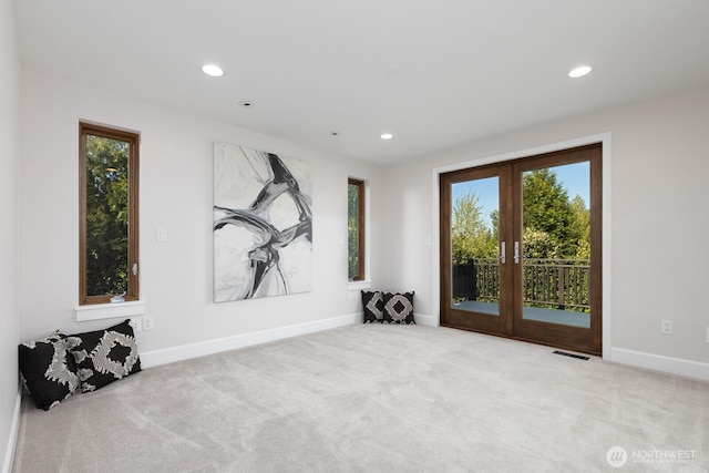 interior space featuring visible vents, recessed lighting, baseboards, and carpet