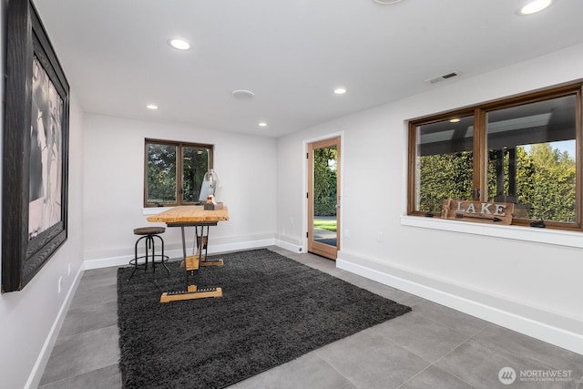 foyer with baseboards, dark tile patterned floors, recessed lighting, and visible vents