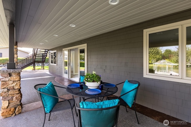 view of patio / terrace with outdoor dining space and stairs