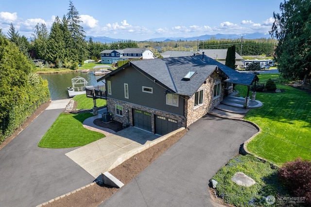 drone / aerial view featuring a water and mountain view