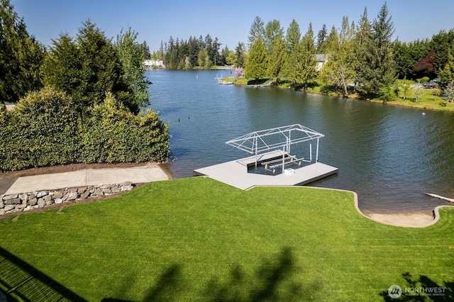 view of dock with a water view and a yard