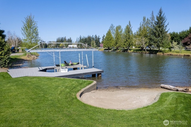dock area with a yard and a water view