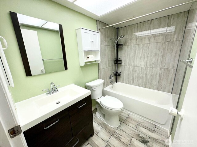 full bath featuring vanity, shower / bathtub combination, and toilet
