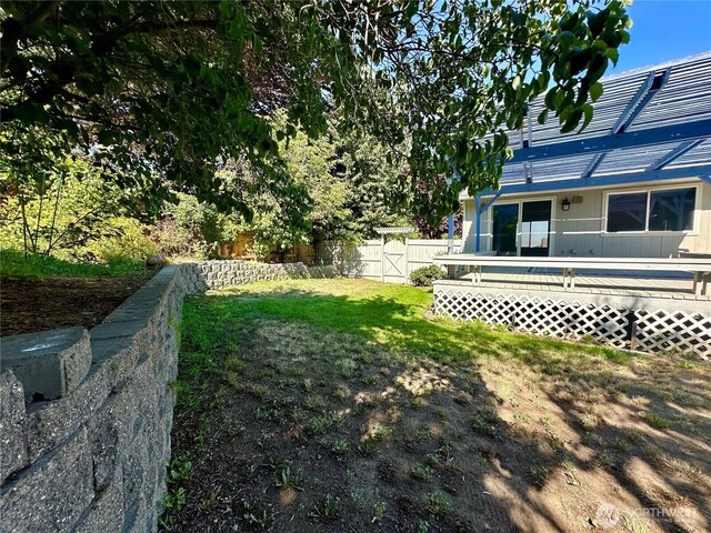 view of yard featuring a deck and fence