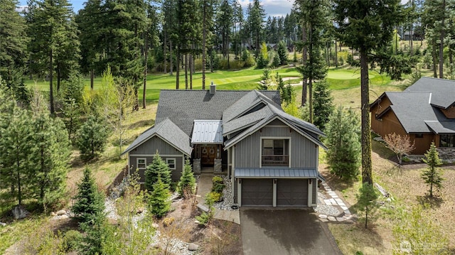330 Maple Leaf Loop, Cle Elum, WA 98922 - view of front of property with a standing seam roof, an attached garage, metal roof, stone siding, and driveway