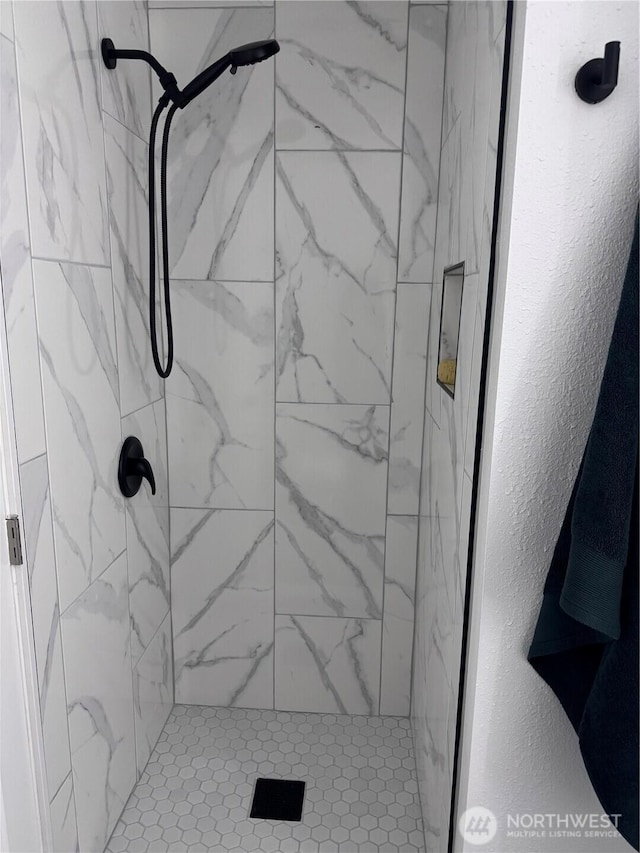 bathroom with a shower stall