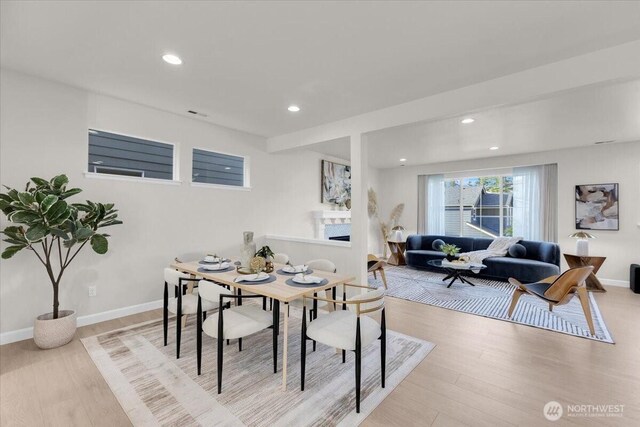 dining space with recessed lighting, baseboards, and light wood-type flooring