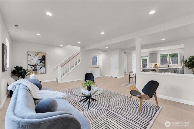 living area featuring stairway, baseboards, recessed lighting, and visible vents