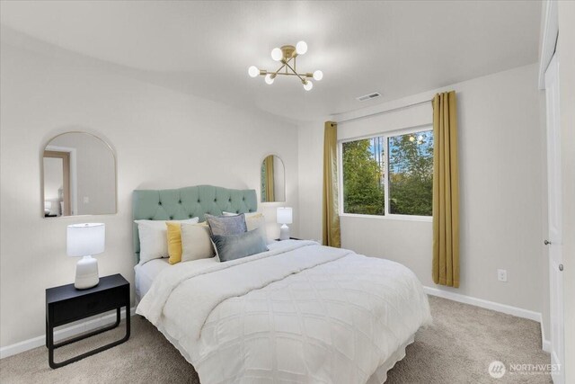 bedroom featuring a chandelier, baseboards, visible vents, and carpet