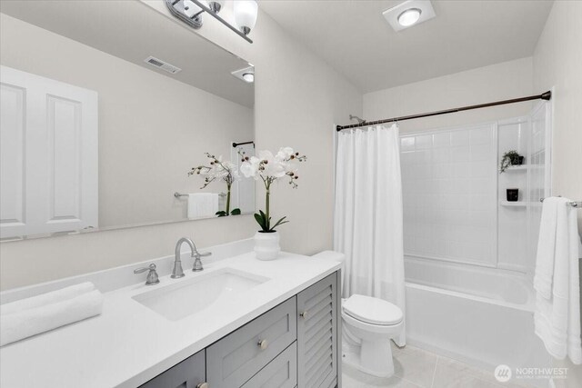 full bath with visible vents, shower / tub combo, tile patterned floors, vanity, and toilet