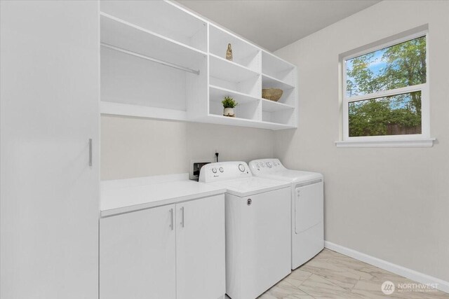 clothes washing area featuring baseboards, independent washer and dryer, and marble finish floor