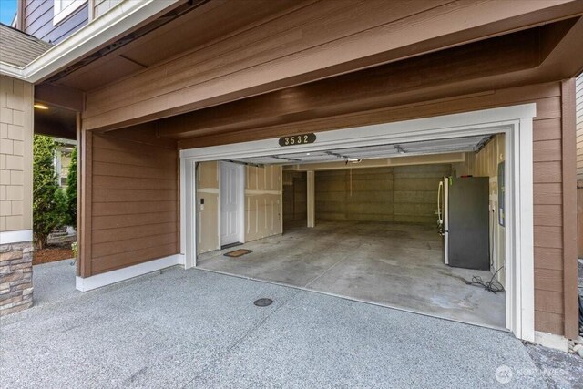 garage with freestanding refrigerator