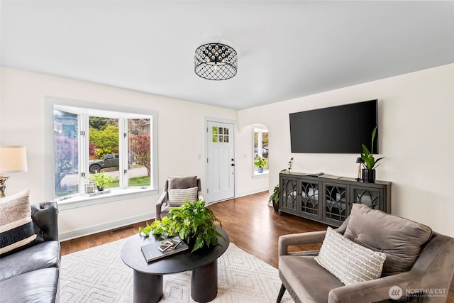 4215 N 27th St, Tacoma, WA 98407 - living area with arched walkways, baseboards, dark wood-type flooring, and a wealth of natural light
