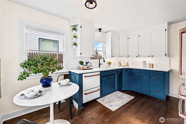 4215 N 27th St, Tacoma, WA 98407 - kitchen with blue cabinetry, tasteful backsplash, dark wood finished floors, a sink, and light countertops