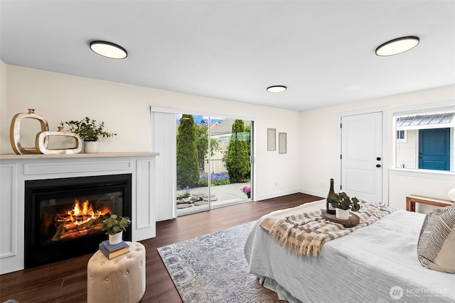 4215 N 27th St, Tacoma, WA 98407 - bedroom featuring access to outside, baseboards, a glass covered fireplace, and dark wood-style floors
