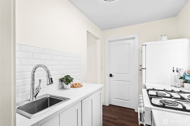 4215 N 27th St, Tacoma, WA 98407 - kitchen featuring light countertops, dark wood-style flooring, white cabinets, and a sink