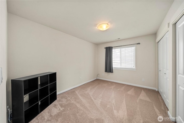 unfurnished bedroom with baseboards and carpet floors