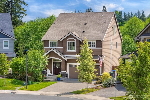 craftsman-style house with a garage, asphalt driveway, a porch, and a shingled roof