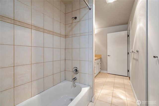 bathroom with baseboards, shower / bathing tub combination, tile patterned flooring, and vanity