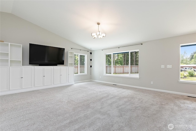 15627 240th St E, Graham, WA 98338 - unfurnished living room with vaulted ceiling, a chandelier, baseboards, plenty of natural light, and carpet