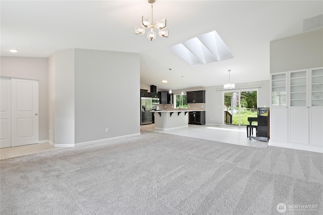 15627 240th St E, Graham, WA 98338 - unfurnished living room featuring light colored carpet, a skylight, a chandelier, lofted ceiling, and baseboards