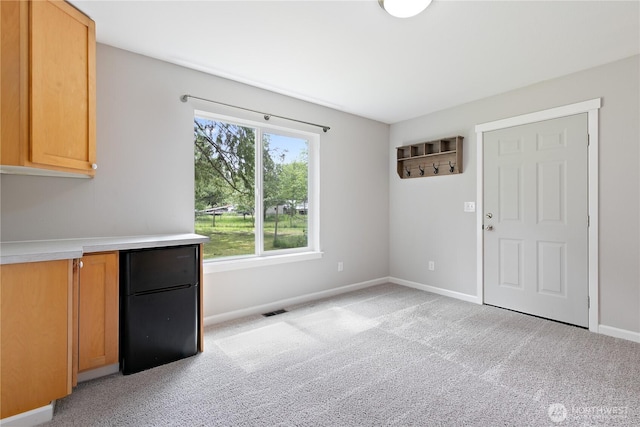 15627 240th St E, Graham, WA 98338 - unfurnished dining area with light colored carpet and baseboards