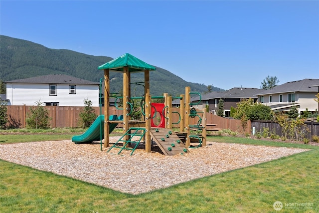 community play area with fence and a mountain view