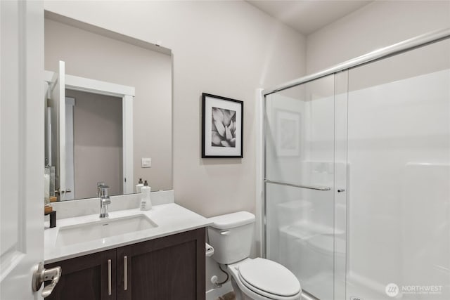 full bath featuring vanity, a shower stall, and toilet