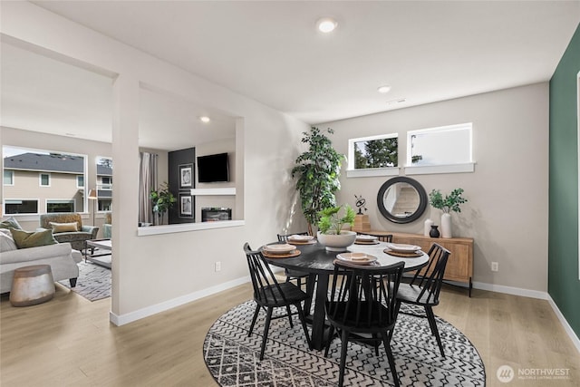 dining space with recessed lighting, baseboards, and wood finished floors