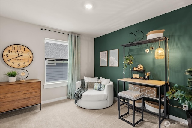 sitting room featuring baseboards and carpet flooring