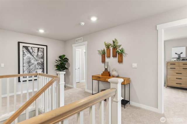 corridor featuring light colored carpet, recessed lighting, baseboards, an upstairs landing, and visible vents