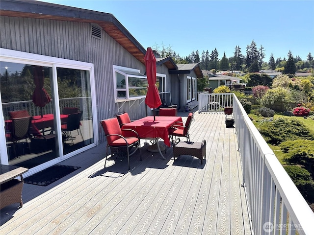wooden deck featuring outdoor dining space