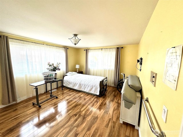 bedroom featuring dark wood finished floors