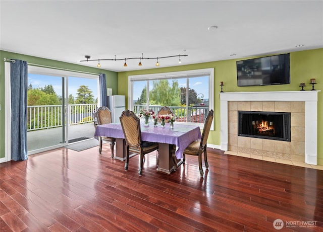 431 12th Pl N, Edmonds, WA 98020 - dining area featuring wood finished floors, a tiled fireplace, and baseboards