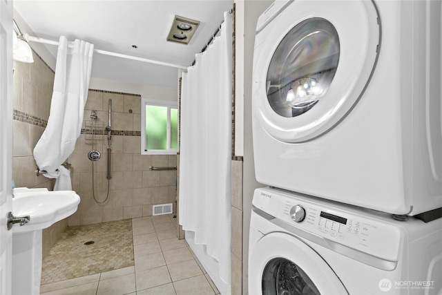 431 12th Pl N, Edmonds, WA 98020 - laundry room featuring estacked washer and dryer and light tile patterned floors