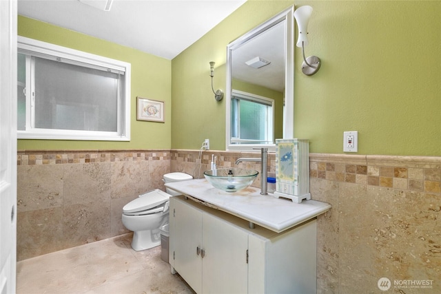 431 12th Pl N, Edmonds, WA 98020 - bathroom featuring tile walls, a wainscoted wall, toilet, tile patterned floors, and vanity