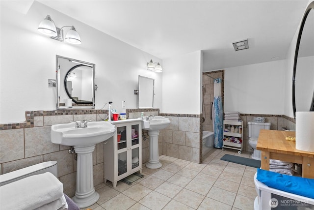 431 12th Pl N, Edmonds, WA 98020 - bathroom with tile walls, tile patterned floors, a wainscoted wall, and shower / bathtub combination with curtain