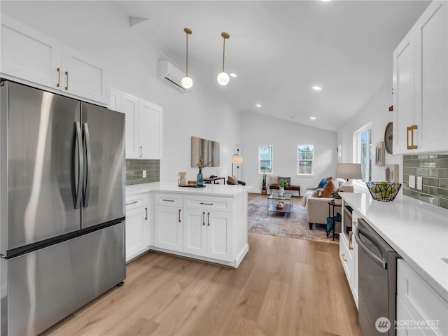 7822 Beverly Blvd Unit B, Everett, WA 98203 - kitchen featuring appliances with stainless steel finishes, a peninsula, light wood-style flooring, light countertops, and recessed lighting