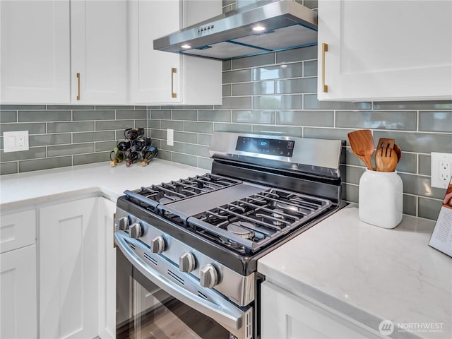 7822 Beverly Blvd Unit B, Everett, WA 98203 - kitchen with gas range, exhaust hood, white cabinetry, tasteful backsplash, and light stone counters