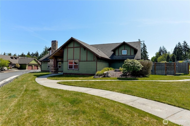 2605A Plum Ct Unit A, Port Angeles, WA 98363 - tudor-style house with a front lawn, fence, and a chimney